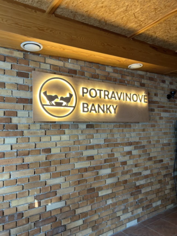 Dřevěné podsvícené logo Potravinové banky na dřevěném podkladu